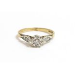 A single stone 9 carat gold ring, the brilliant cut illusion set with a pair of single cuts to