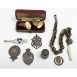 A pair of cufflinks, stamped '9ct Gold on Silver'; with two silver watch fobs; a silver thimble