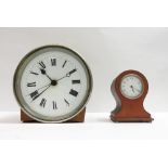 A 20th century desk clock with a white enamel dial and Roman numerals, along with brass cased