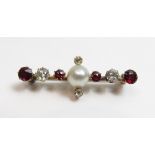 A diamond, ruby and pearl brooch, the central pearl (untested and unwarranted) of approximately 6.