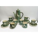 A 20th century hand painted green glazed coffee service, each piece decorated with a horse