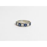 A diamond and sapphire 18 carat white gold half hoop ring, set with four sapphires and three