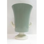 Keith Murray for Wedgwood, a twin handled urn/vase in a celadon and white glaze, 20.5cm high