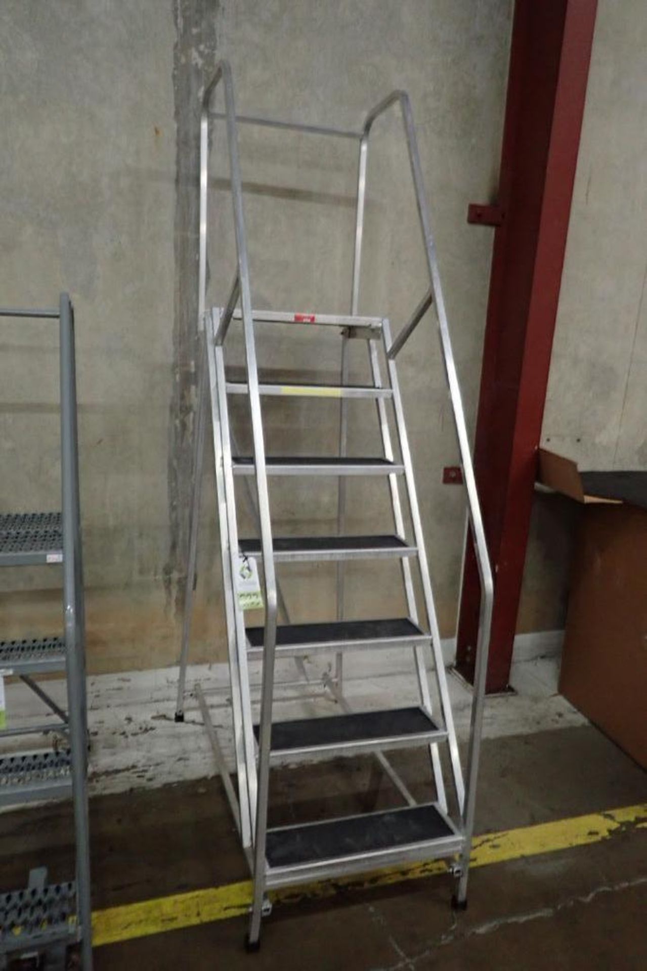 PW Platforms 7-step aluminum rolling warehouse ladder. **Rigging Fee: $25**