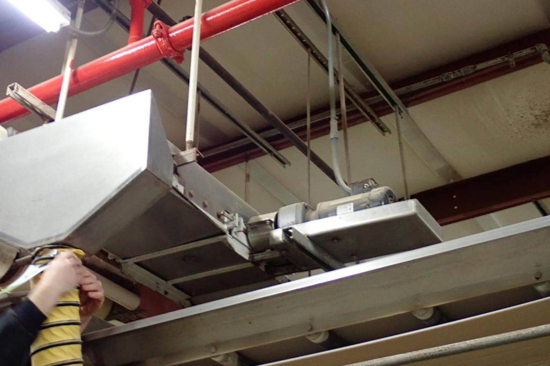 SS belt conveyor, 60 in. long x 18 in. wide, suspended from ceiling. **Rigging Fee: $250** - Image 2 of 3