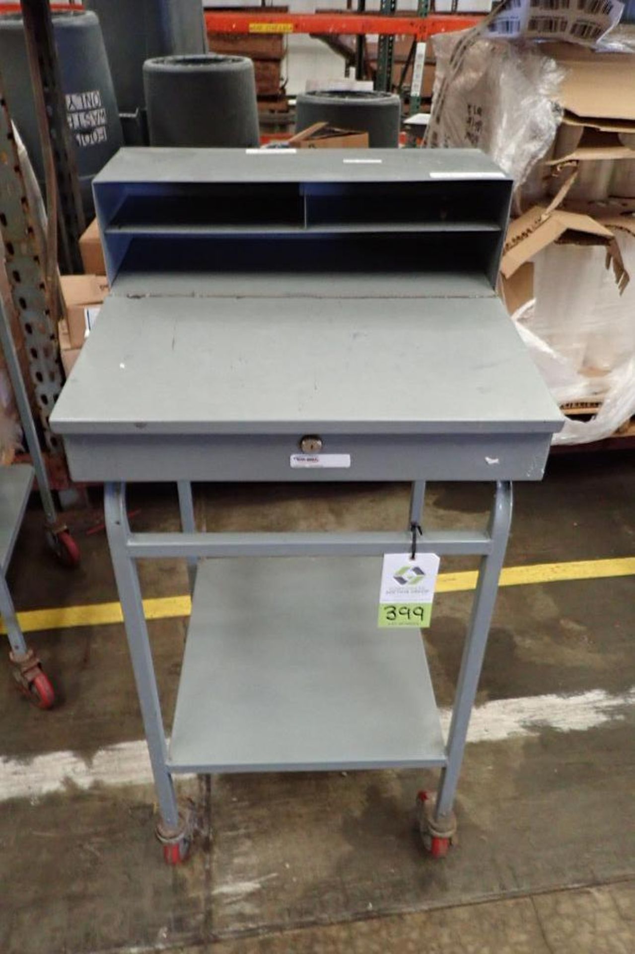 Win-Holt mild steel shipping desk on casters. **Rigging Fee: $10**