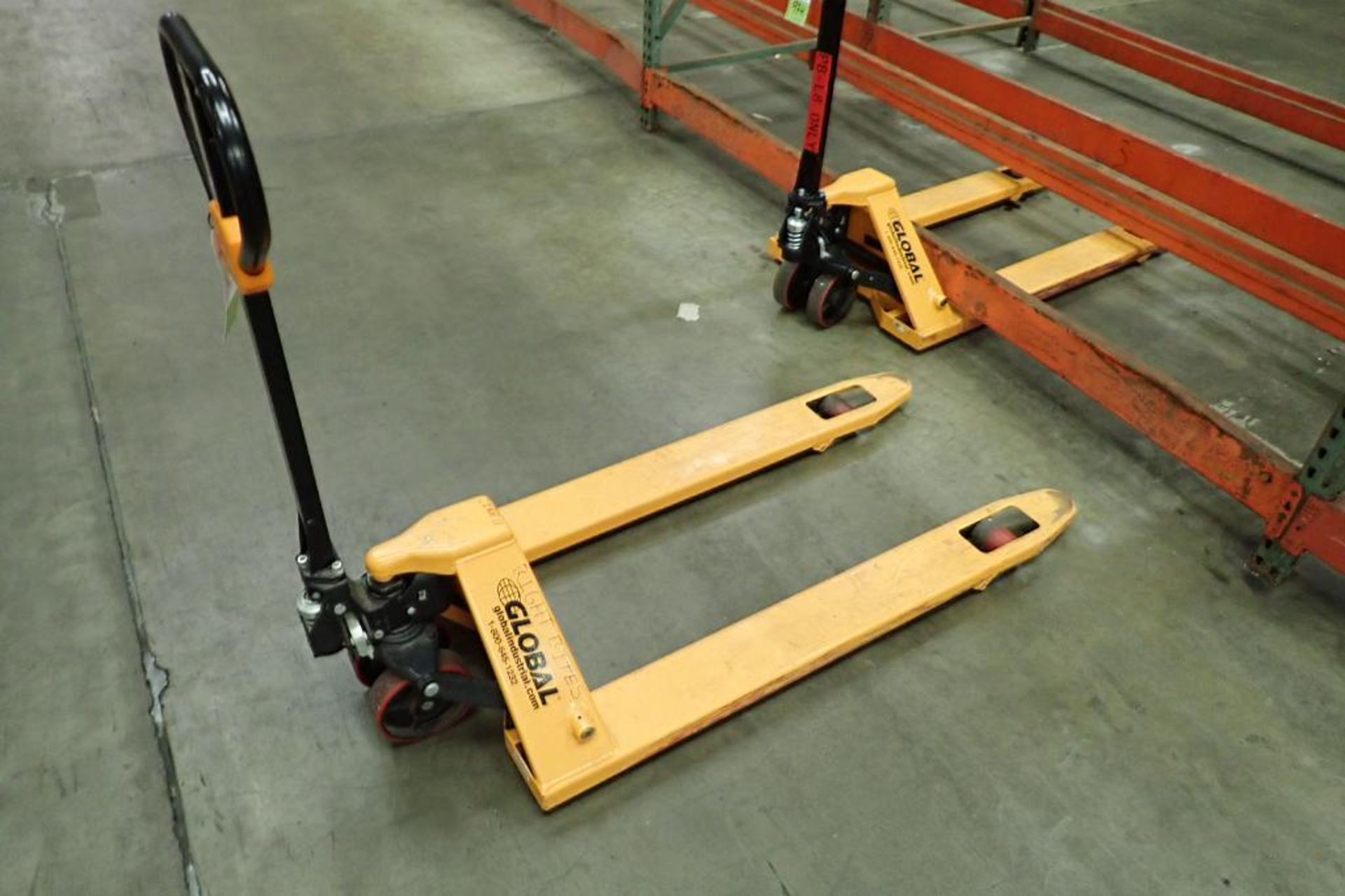 Global Industrial 5500 lb hand pallet jack, SN F695067, yellow. **Rigging Fee: $10** - Image 2 of 6