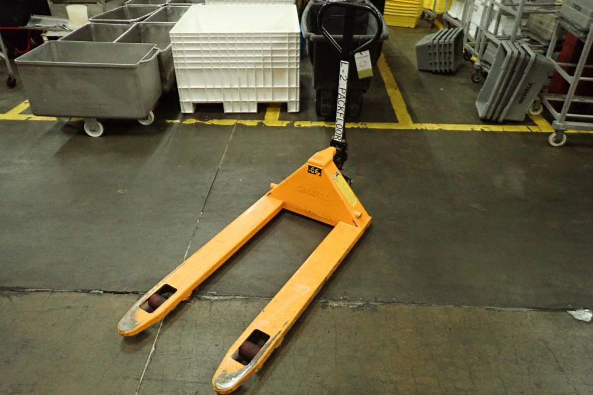 Global Industrial pallet jack, 5500 lb. capacity, SN E698805, yellow.. **Rigging Fee: $10**
