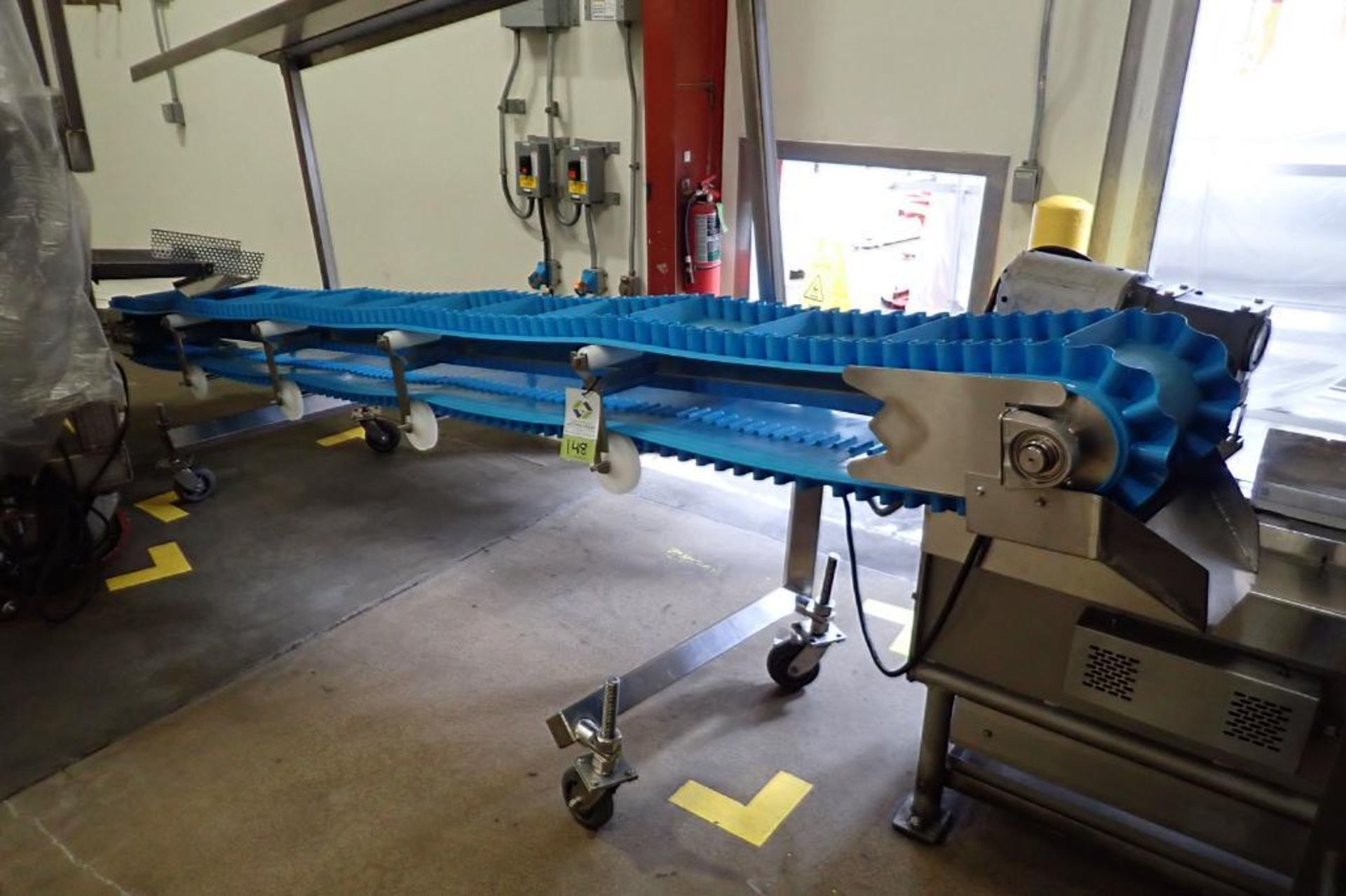 SS incline blue cleated belt conveyor, 14 ft. long x 12 in. wide, 24 in. infeed x 50 in. discharge,