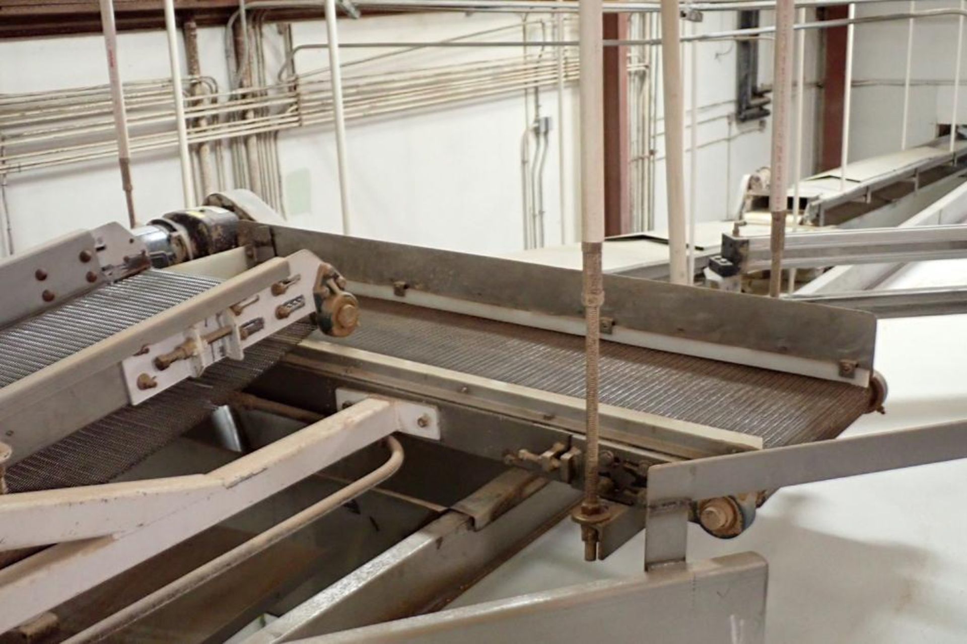 Wire belt conveyor, 48 in. long x 18 in. wide, mild steel frame, suspended from ceiling. **Rigging F