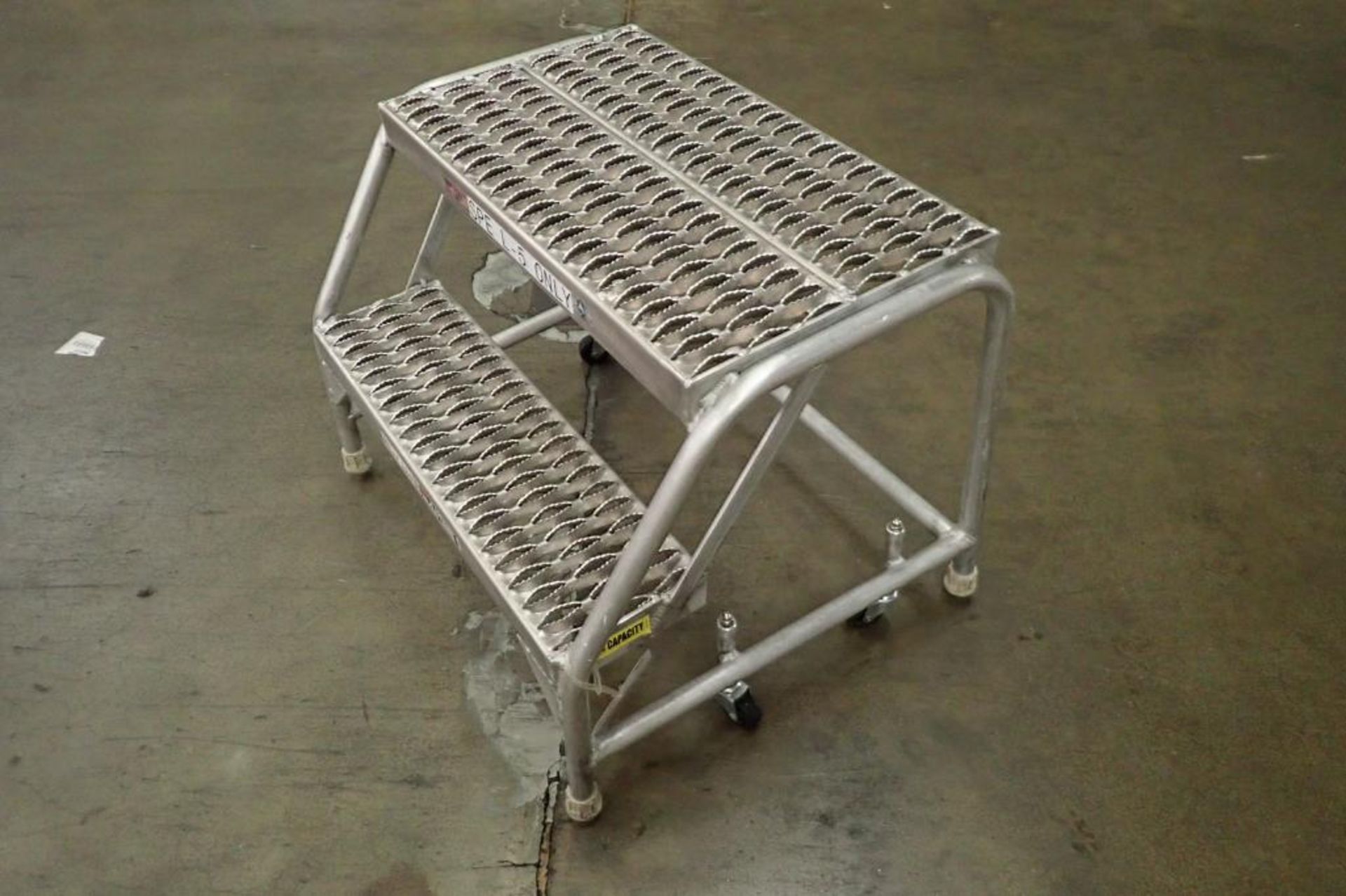 Cotterman 2-step aluminum rolling ladder. **Rigging Fee: $25** - Image 2 of 4