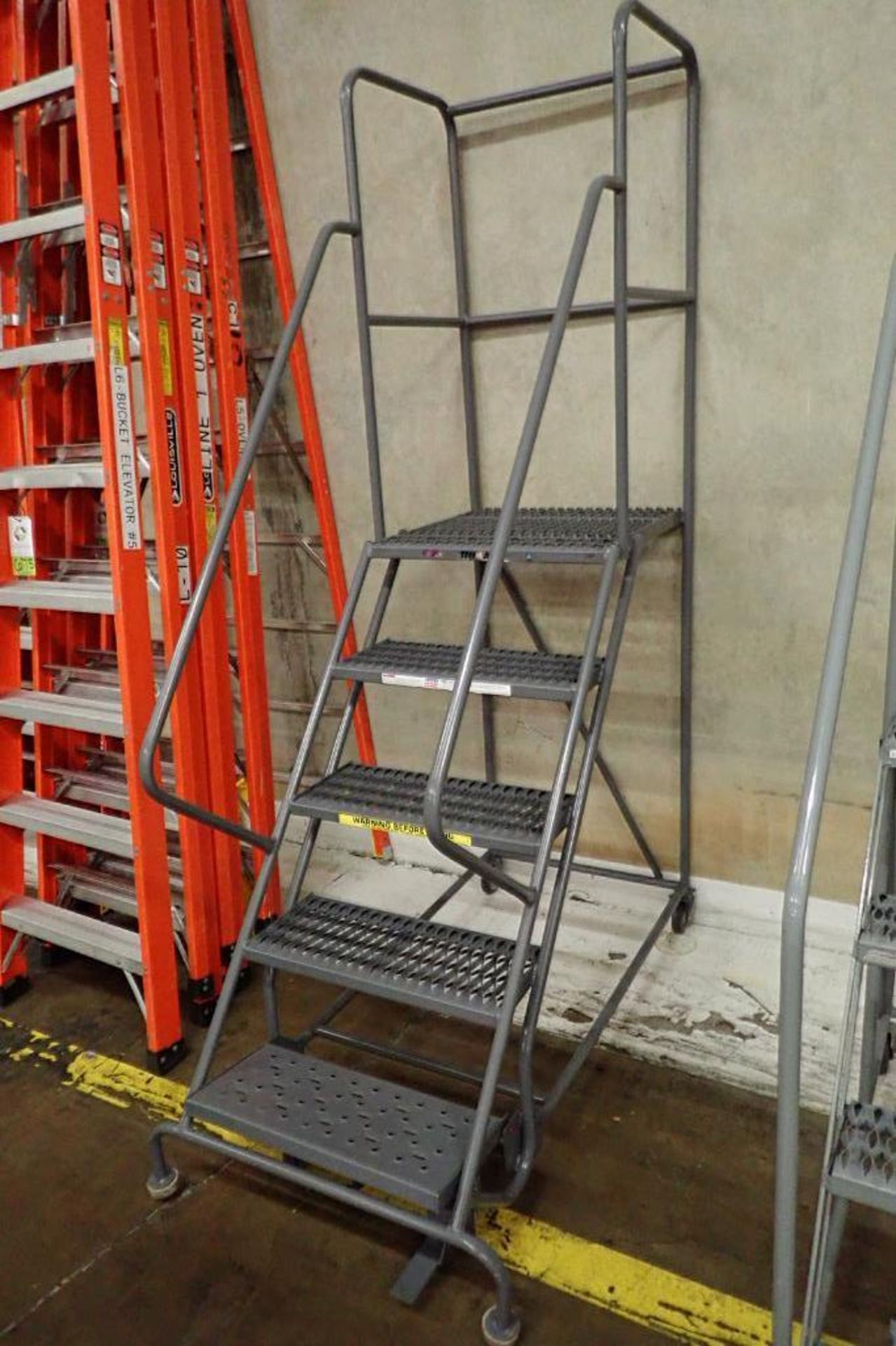 Tri Arc 5-step mild steel rolling warehouse ladder. **Rigging Fee: $50** - Image 2 of 4