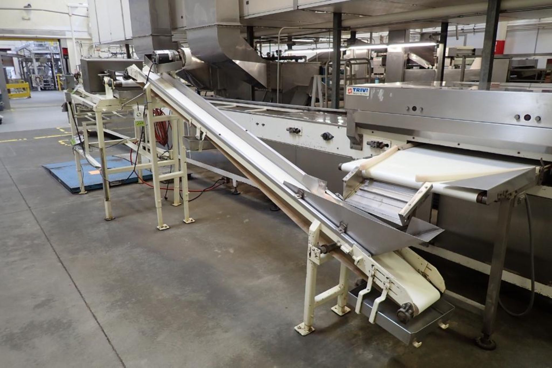 Incline belt conveyor, 12 ft. long x 8 in. wide, 24 in. infeed, 68 in. discharge, mild steel frame.