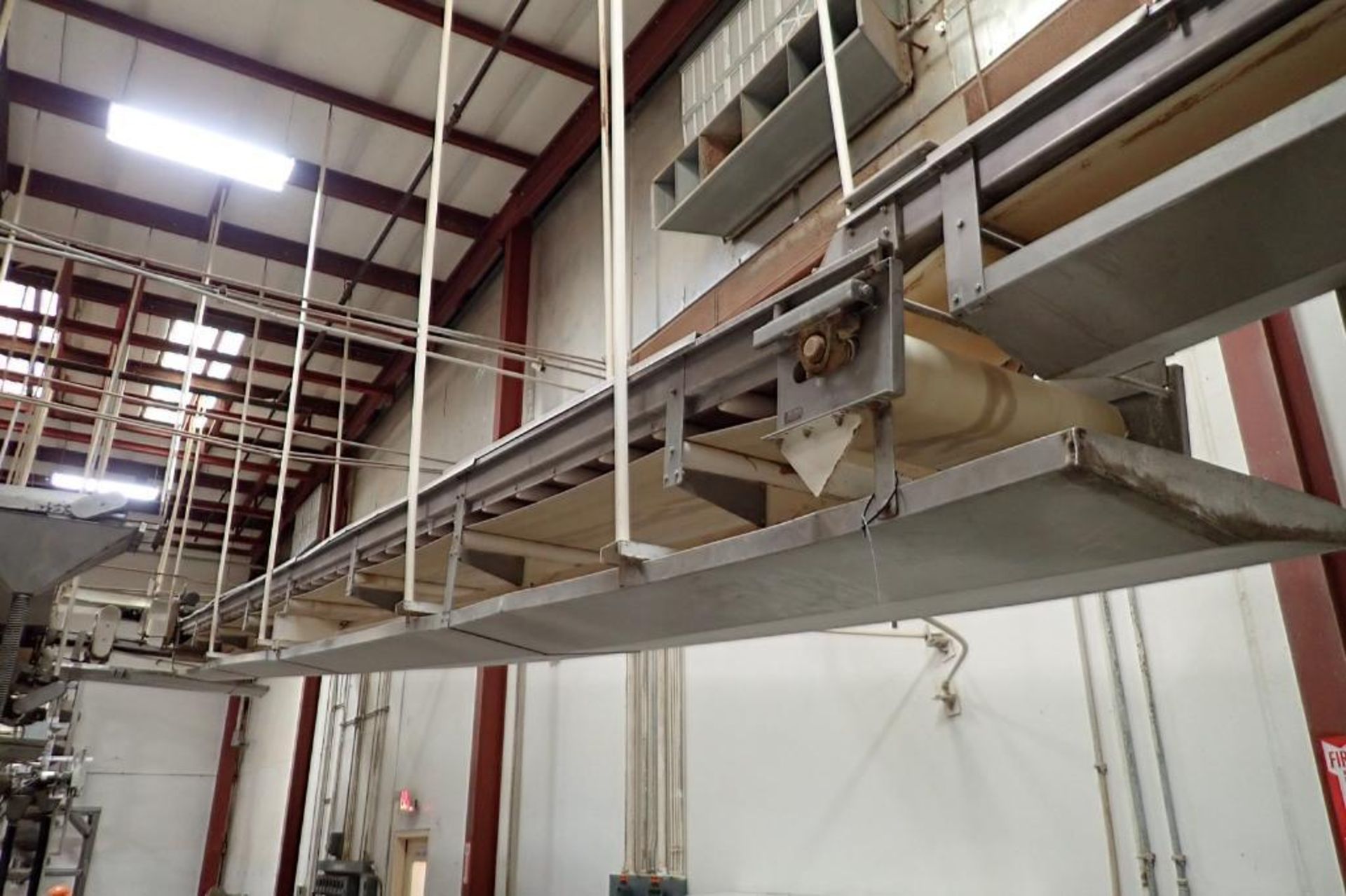 SS belt conveyor, 36 ft. long x 24 in. wide, suspended from ceiling, with motor and drive. **Rigging