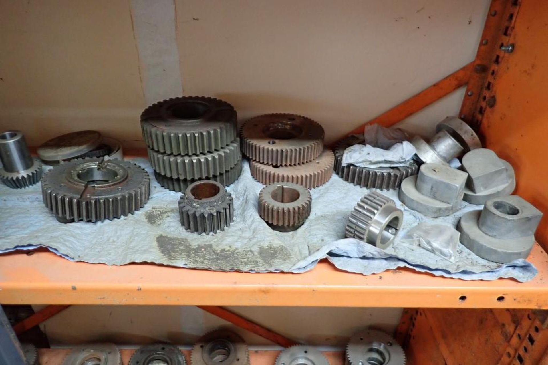 Contents only of 4 sections of shelving of assorted parts, gears, lug chain. **Rigging Fee: $150** - Image 9 of 21