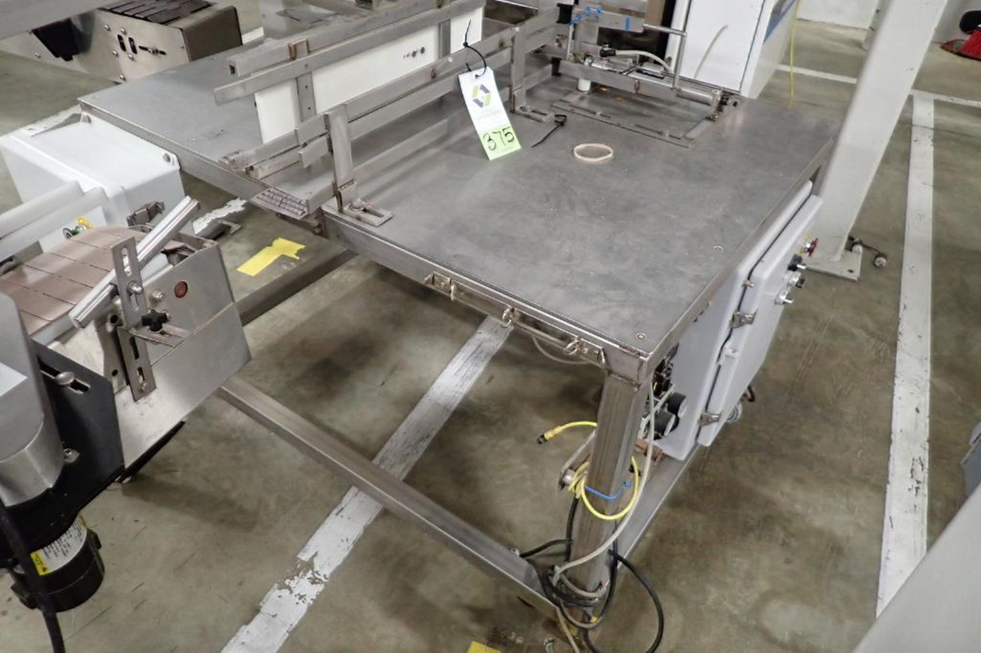 SS table on wheel, right angle feed to filling plastic jars, pneumatic push when full. **Rigging Fee - Image 2 of 8
