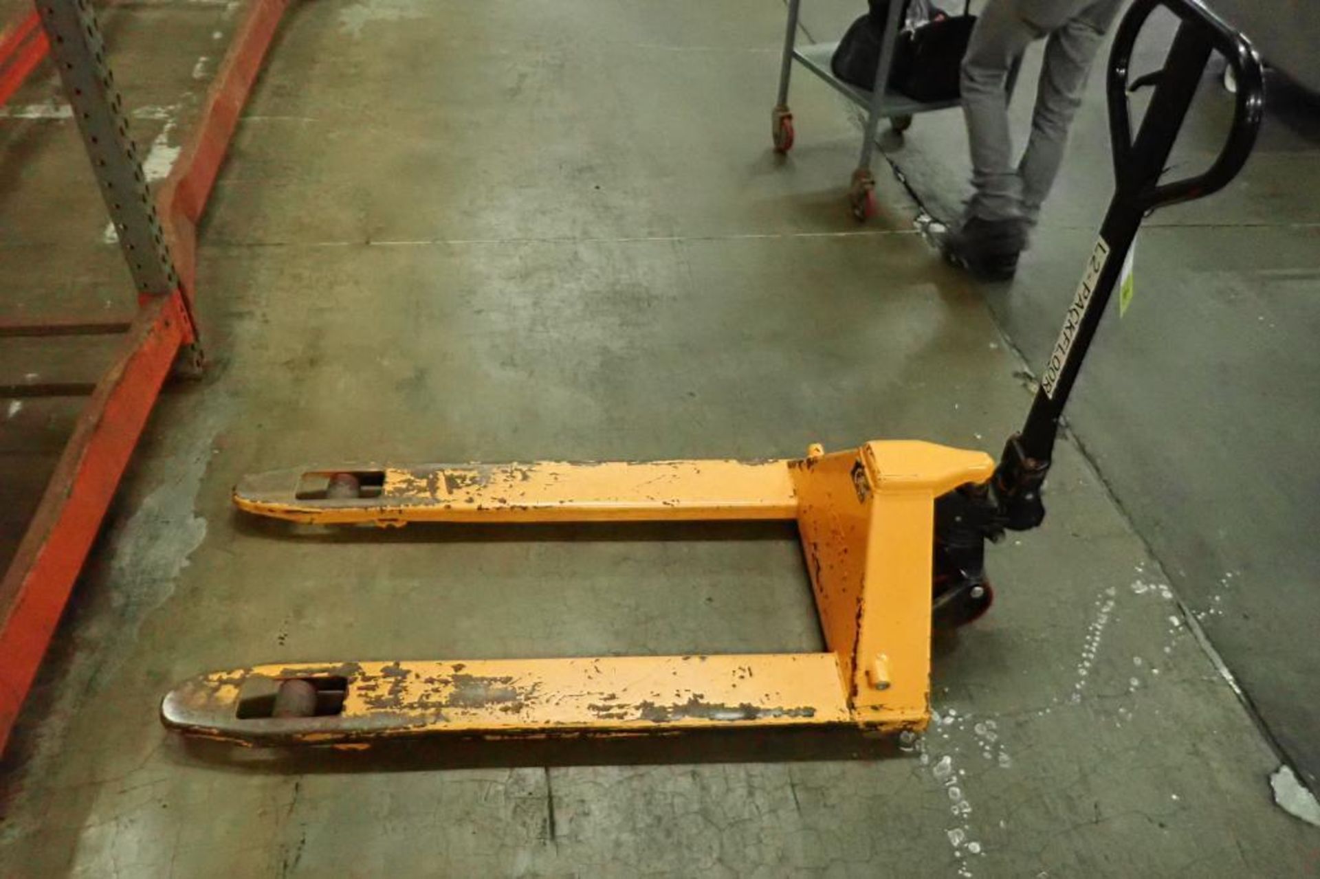 Global Industrial pallet jack, 5500 lb. capacity, SN E689044, yellow. **Rigging Fee: $10**