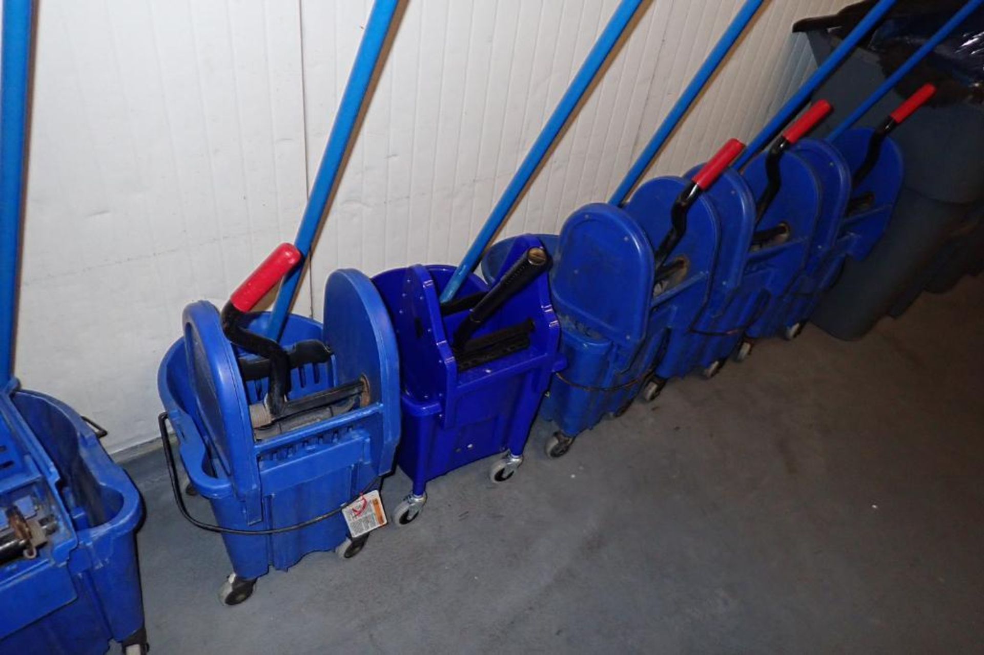 Blue mops and mop buckets, approximately 8. **Rigging Fee: $75** - Image 4 of 6