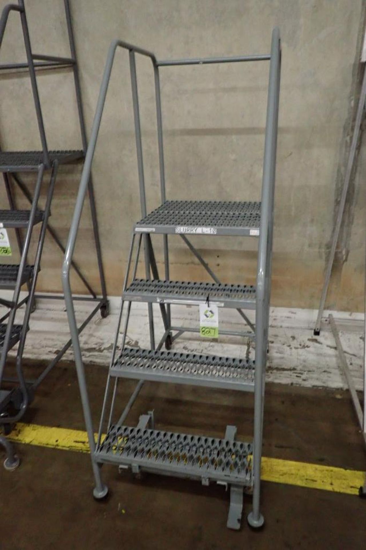 Cotterman 4-step mild steel rolling warehouse ladder. **Rigging Fee: $25**