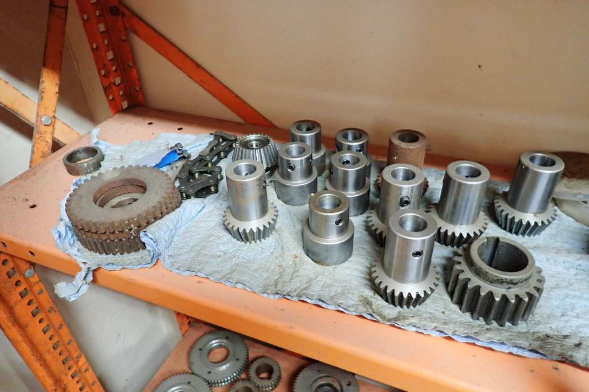 Contents only of 4 sections of shelving of assorted parts, gears, lug chain. **Rigging Fee: $150** - Image 10 of 21