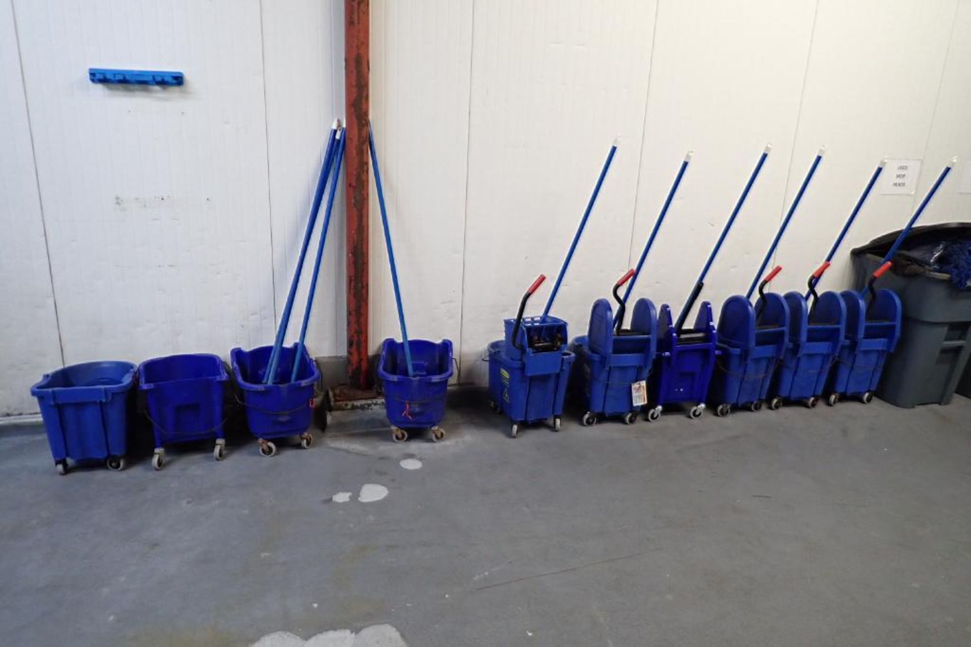 Blue mops and mop buckets, approximately 8. **Rigging Fee: $75**