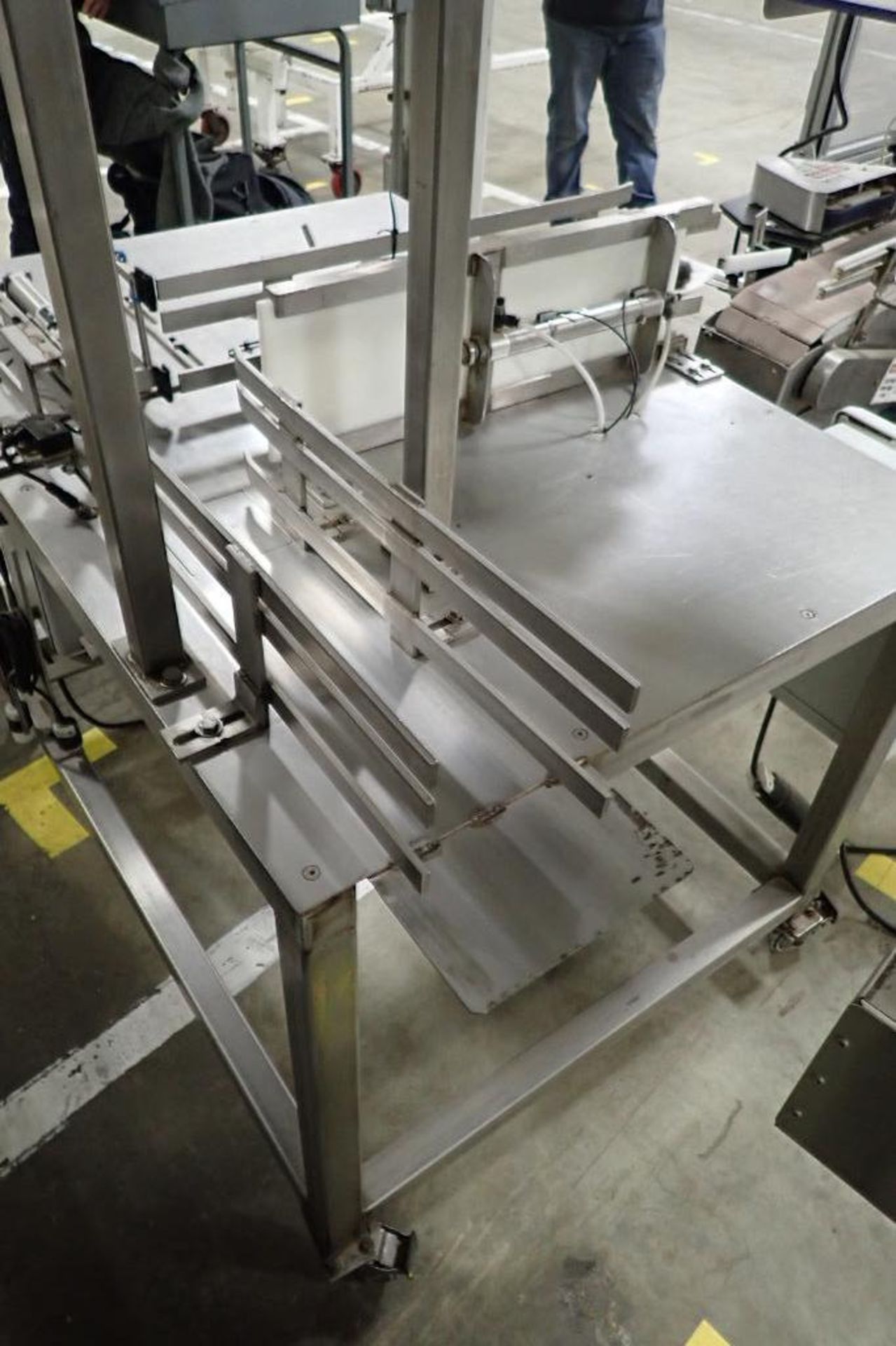 SS table on wheel, right angle feed to filling plastic jars, pneumatic push when full. **Rigging Fee - Image 6 of 8
