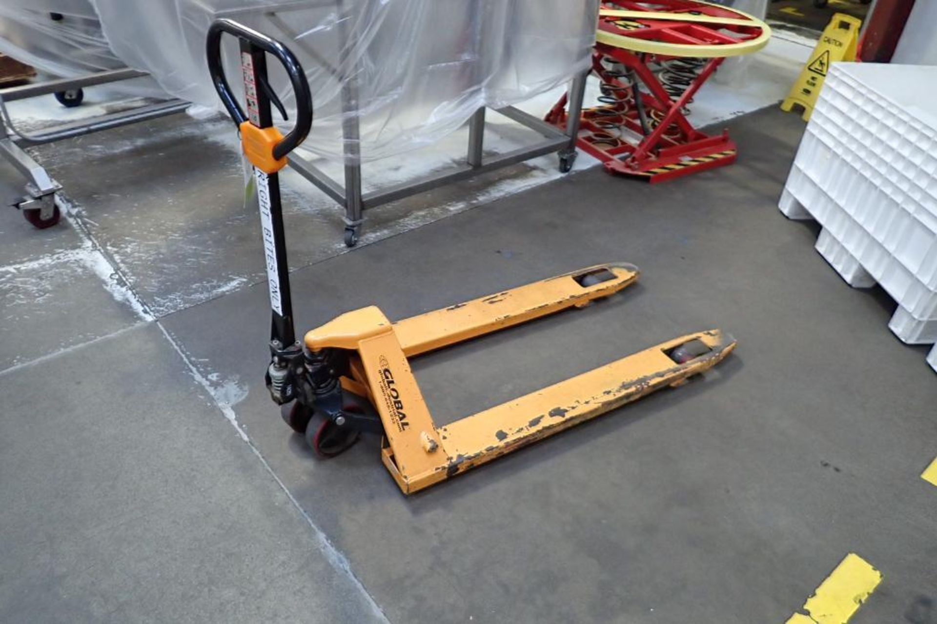 Global Industrial pallet jack, 5500 lb. capacity, SN E689045, yellow.. **Rigging Fee: $10**