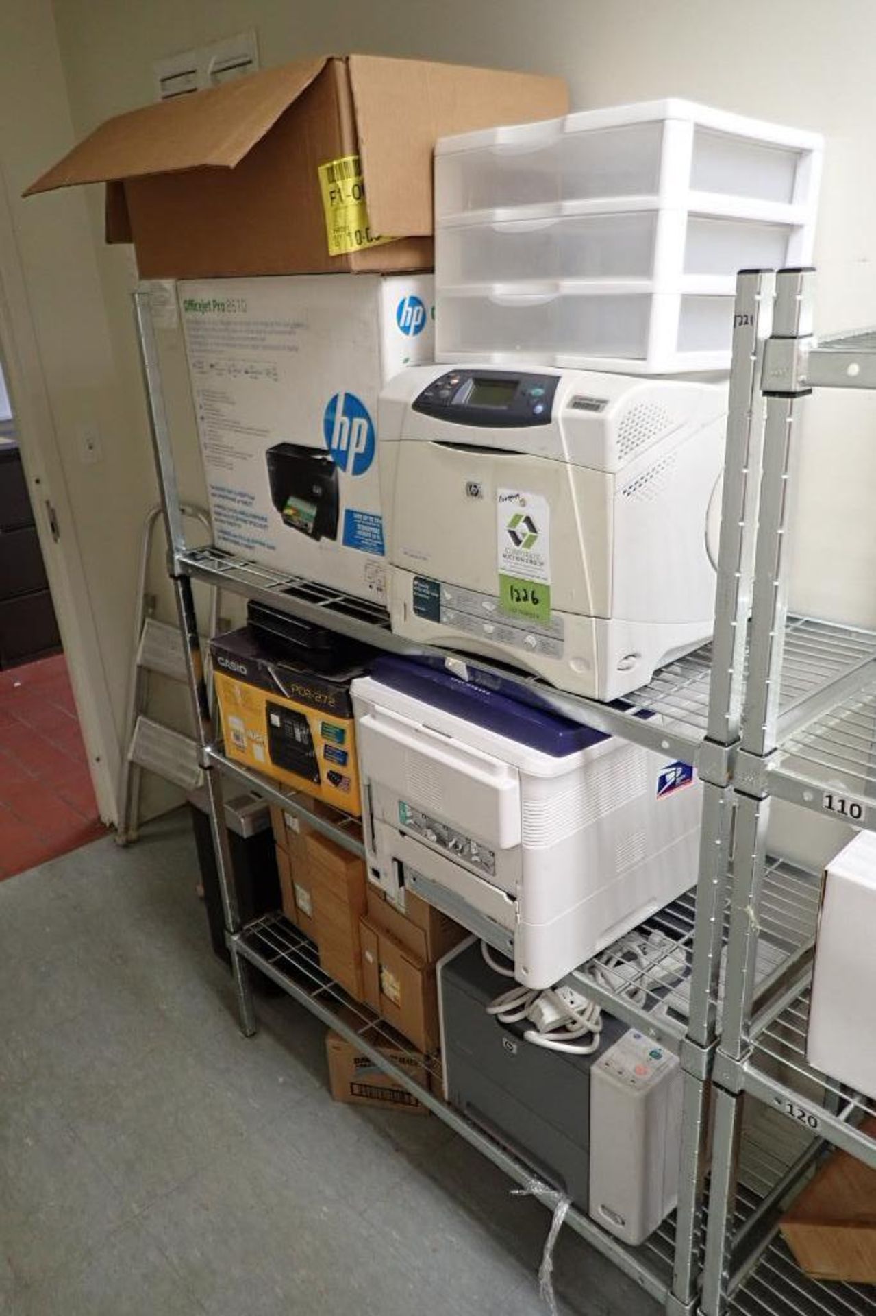 Contents of shelf including laser printers and ink jet printers