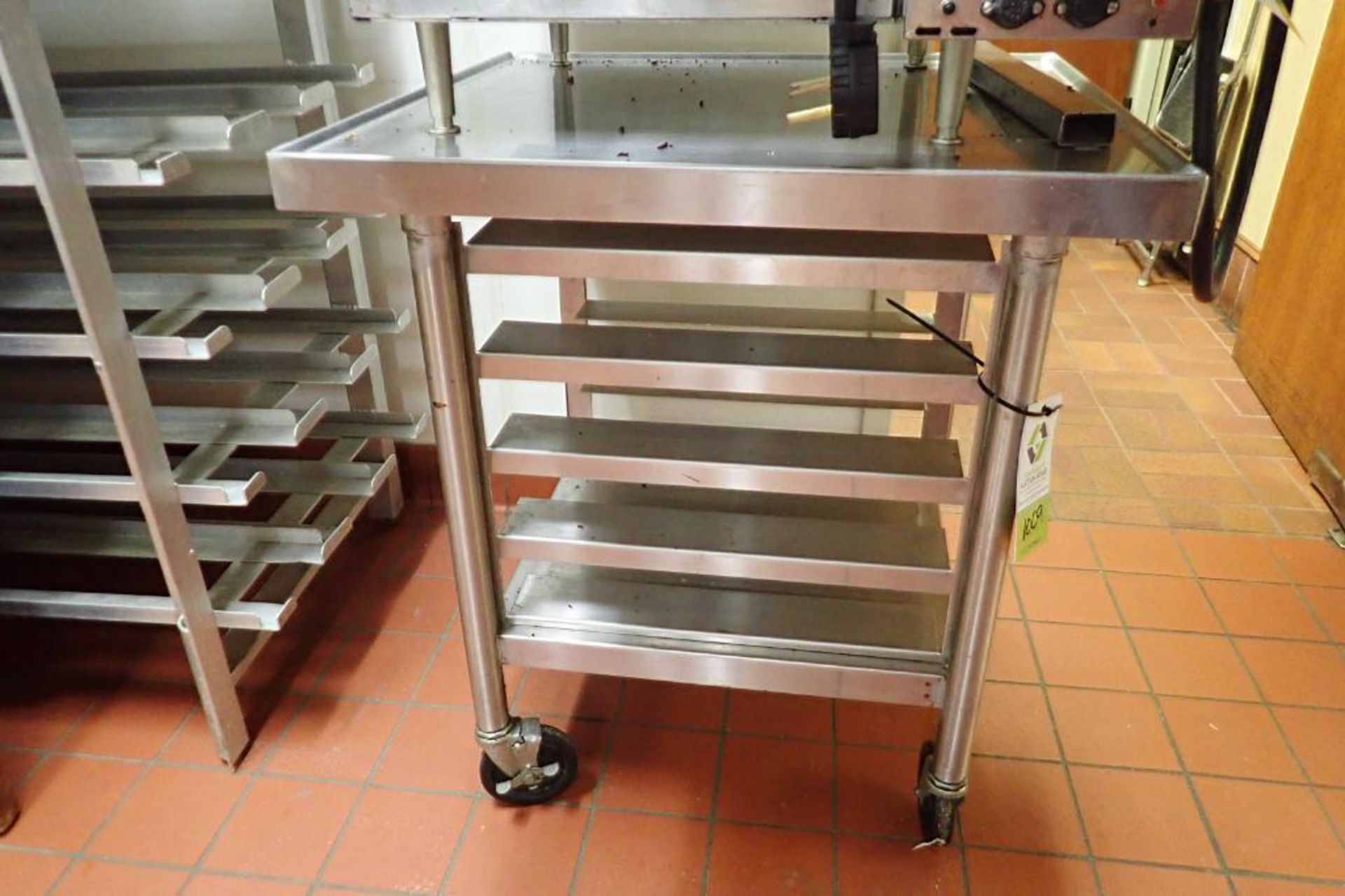 SS table on casters with 4 shelves for trays