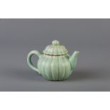 A Chinese chrysanthemum shaped celadon glazed stoneware teapot and cover, 18th/19th C.