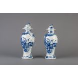 A pair of Chinese blue and white vases and covers with figures in a garden, Kangxi mark, 19th C.