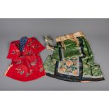 A Chinese embroidered red children's robe, green silk woman's dress and a pair of lotus shoes, Qing