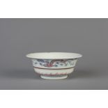 A Chinese blue, white and copper red 'dragon and phoenix' bowl, Kangxi mark, 19th/20th C.