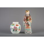 A Chinese famille rose figure of an immortal and a famille rose jar and cover, 19th C.