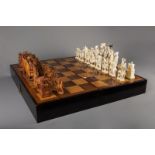A large Chinese carved ivory chess set with board, second quarter 20th C.
