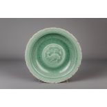 A Chinese celadon charger with incised design, possibly Ming