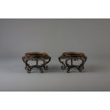 A pair of Chinese bronze open worked stands, Qianlong/Jiaqing