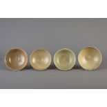 Four Chinese green glazed bowls with underglaze design, Song