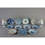 Fourteen Dutch Delft blue and white and polychrome dishes and a pair of vases and covers, 18th C.