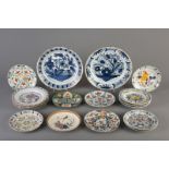Seventeen Dutch Delft blue and white, manganese and polychrome dishes and chargers, 18th C.