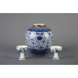 A Chinese blue and white ginger jar and two stem cups with floral design, Qianlong