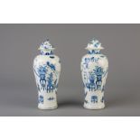 A pair of Chinese blue and white vases and covers with antiquities design, 19th C.