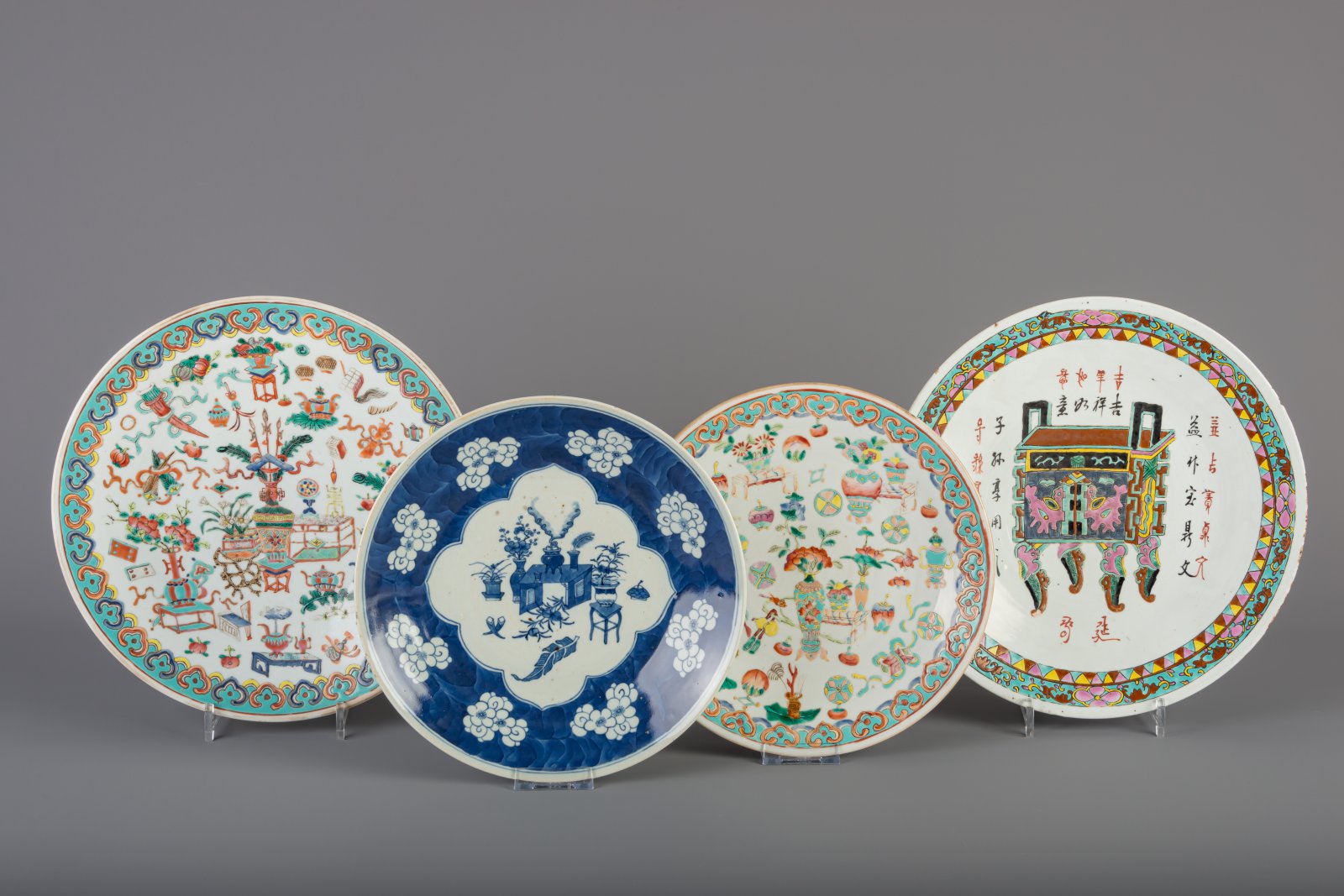 Three Chinese famille rose chargers and a blue and white charger, 19th C.