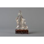 A Chinese carved rock crystal figure holding a flower, 19th/20th C.
