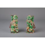 A pair of sancai glazed biscuit Buddhist lion joss-stick holders, Kangxi