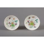 A pair of Chinese famille rose floral relief decorated saucers, Yongzheng