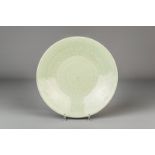 A Chinese celadon dish with incised floral design, 19th C.