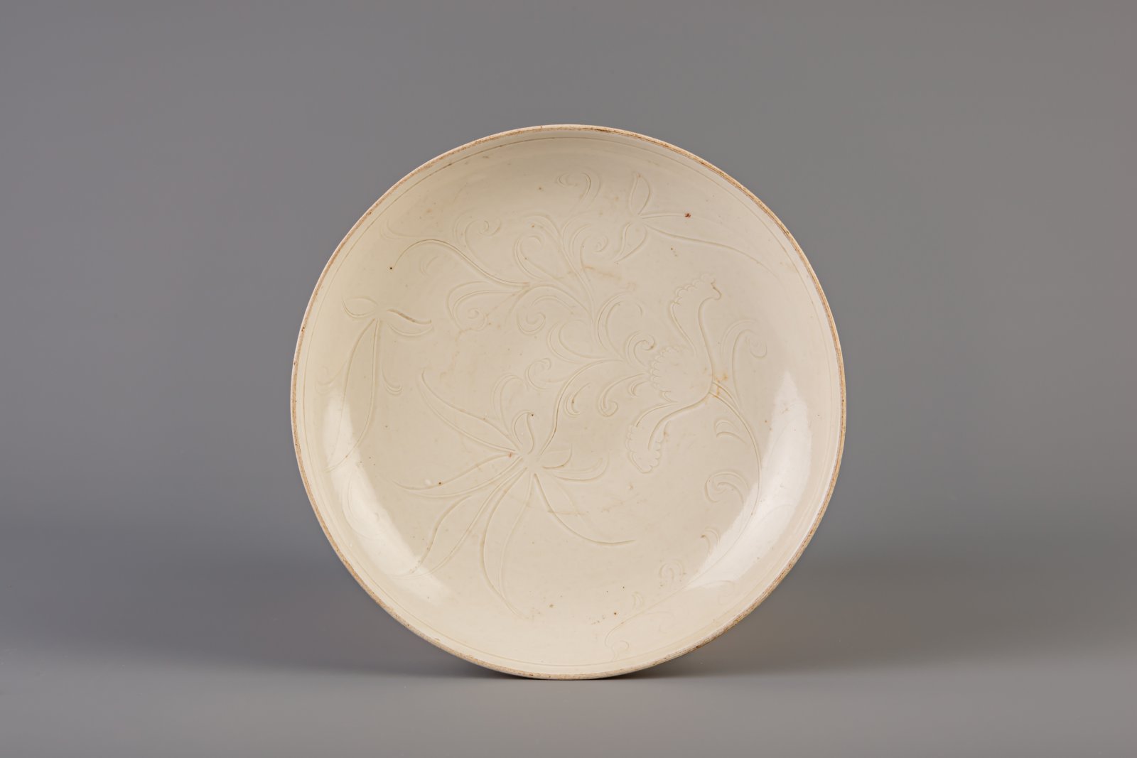 A Chinese carved white glazed dingyao dish, Ming or later
