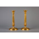 A pair of Neoclassical gilt bronze candlesticks, France, 19th C.