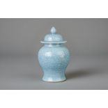 A Chinese monochrome blue vase and cover with incised floral design, 19th/20th C.